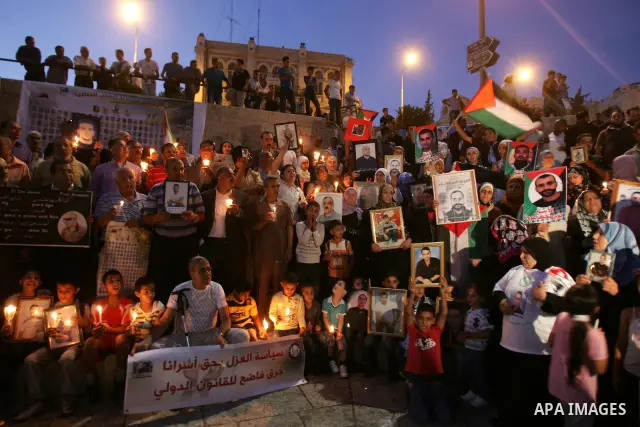 Palestinians take part in a protest calling for the release of Palestinian prisoners from Israeli jails and in support of inmates in hunger strike on October 11, 2011 outside Damascus Gate in Jerusalem's Old City. Both t...