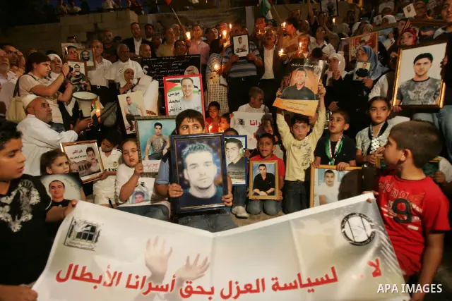 Palestinians take part in a protest calling for the release of Palestinian prisoners from Israeli jails and in support of inmates in hunger strike on October 11, 2011 outside Damascus Gate in Jerusalem's Old City. Accord...