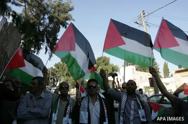 Palestinians take part in a protest calling for the release of Palestinian prisoners from Israeli jails and in support of inmates in hunger strike on October 11, 2011 outside the Red Cross buildings in Jerusalem's Old Ci...