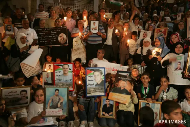 Palestinians take part in a protest calling for the release of Palestinian prisoners from Israeli jails and in support of inmates in hunger strike on October 11, 2011 outside Damascus Gate in Jerusalem's Old City. Accord...
