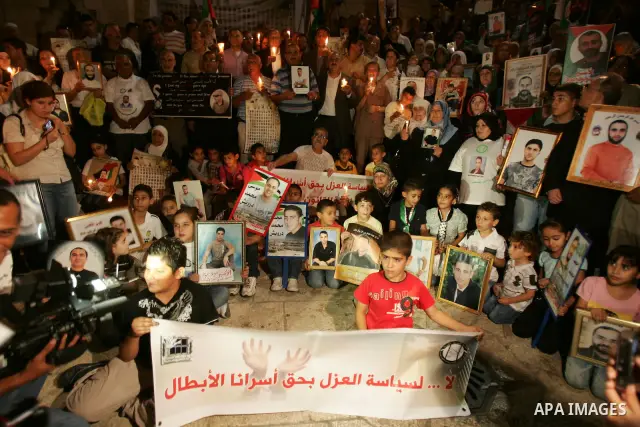 Palestinians take part in a protest calling for the release of Palestinian prisoners from Israeli jails and in support of inmates in hunger strike on October 11, 2011 outside Damascus Gate in Jerusalem's Old City. Accord...