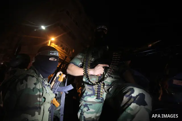 Masked Palestinian Hamas militants celebrate the announcement of a prisoner swap deal with Israel, in the Jebaliya refugee camp northern Gaza Strip, Tuesday, Oct. 11, 2011. Israeli and Hamas have reached a deal to free c...