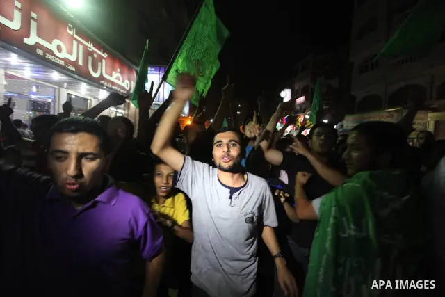 Palestinian Hamas supporters celebrate the announcement of a prisoner swap deal with Israel, in the Jebaliya refugee camp, northern Gaza Strip, Tuesday, Oct. 11, 2011. Israeli and Hamas have reached a deal to free captur...