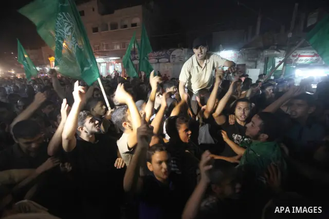Palestinian Hamas supporters celebrate the announcement of a prisoner swap deal with Israel, in the Jebaliya refugee camp, northern Gaza Strip, Tuesday, Oct. 11, 2011. Israeli and Hamas have reached a deal to free captur...