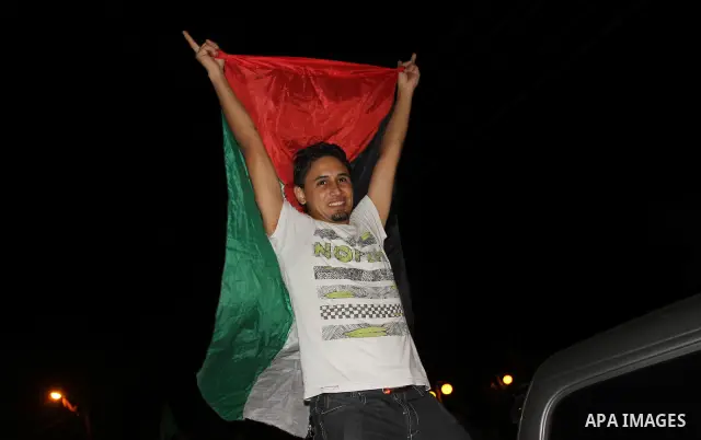 Palestinian members of Hamas celebrate a deal that will see Palestinian detainees freed in exchange for captured Israeli soldier Gilad Shalit on October 11, 2011, in Gaza City. Shalit was captured in 2006 by Hamas-allied...