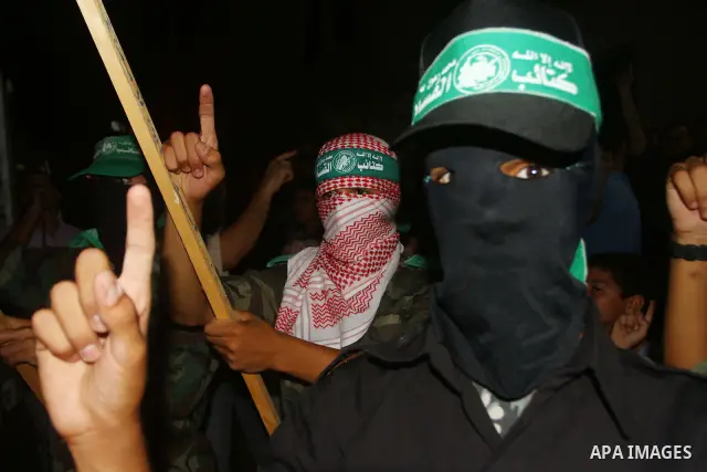 Palestinian members of Hamas celebrate a deal that will see Palestinian detainees freed in exchange for captured Israeli soldier Gilad Shalit on October 11, 2011, in Deir al-Balah in the central Gaza Strip. Shalit was ca...