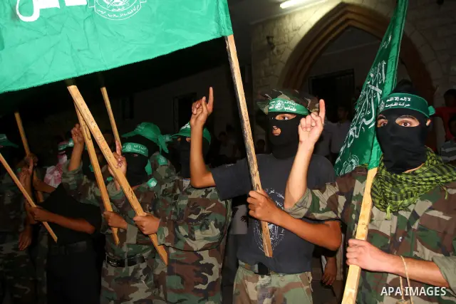 Palestinian members of Hamas celebrate a deal that will see Palestinian detainees freed in exchange for captured Israeli soldier Gilad Shalit on October 11, 2011, in Deir al-Balah in the central Gaza Strip. Shalit was ca...