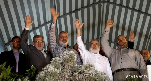 Hamas leaders waves to the crwed as they celebrate a deal that will see Palestinian detainees freed in exchange for captured Israeli soldier Gilad Shalit on October 11, 2011, in Gaza City. Shalit was captured in 2006 by...