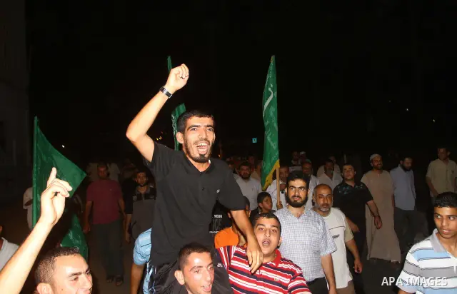 Palestinian members of Hamas celebrate a deal that will see Palestinian detainees freed in exchange for captured Israeli soldier Gilad Shalit on October 11, 2011, in Deir al-Balah in the central Gaza Strip. Shalit was ca...
