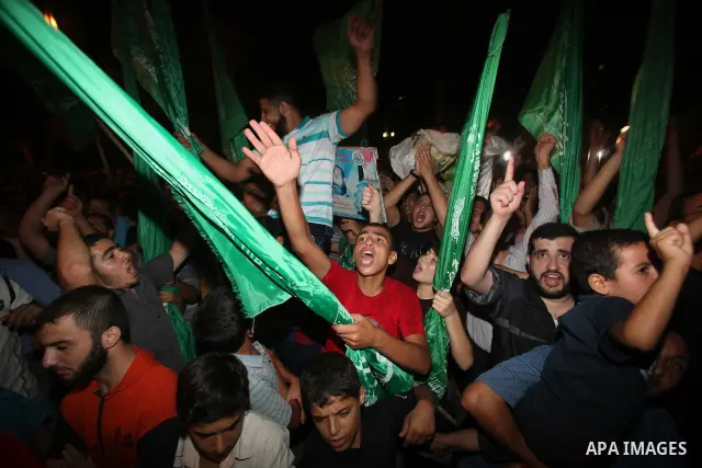 Palestinian members of Hamas celebrate a deal that will see Palestinian detainees freed in exchange for captured Israeli soldier Gilad Shalit on October 11, 2011, in Gaza City. Shalit was captured in 2006 by Hamas-allied...