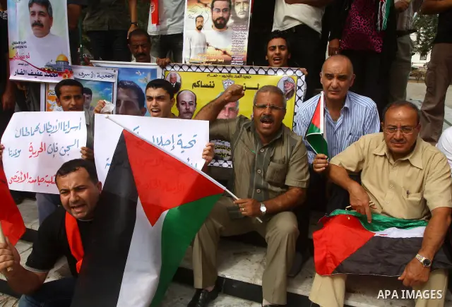 Palestinians celebrate a deal that will see Palestinian detainees freed in exchange for captured Israeli soldier Gilad Shalit on October 12, 2011 in Gaza City. Israel and Hamas have reached a deal that would see the rele...