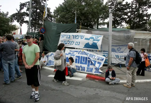 Friends and supporters of Noam and Aviva Shalit, parents of abducted Israeli soldier Gilad Shalit who was captured in 2006 by Hamas-allied militants in the Gaza Strip, gather at the family's protest tent on the 1,935th d...
