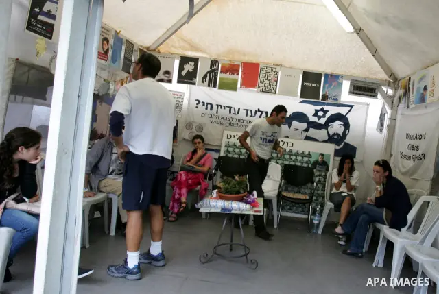 Friends and supporters of Noam and Aviva Shalit, parents of abducted Israeli soldier Gilad Shalit who was captured in 2006 by Hamas-allied militants in the Gaza Strip, gather at the family's protest tent on the 1,935th d...