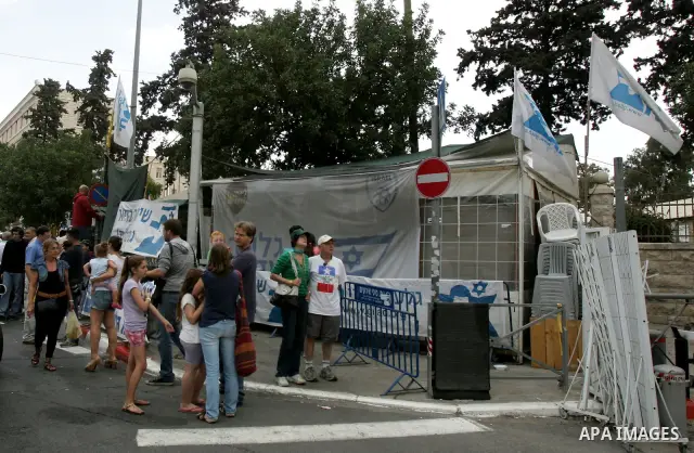 Friends and supporters of Noam and Aviva Shalit, parents of abducted Israeli soldier Gilad Shalit who was captured in 2006 by Hamas-allied militants in the Gaza Strip, gather at the family's protest tent on the 1,935th d...