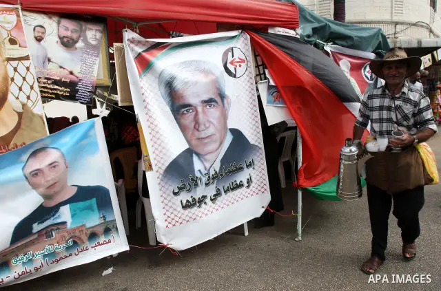 Palestinians take part in a protest calling for the release of Palestinian prisoners from Israeli jails, in the West Bank city of Nablus, Wednesday, Oct. 12, 2011. Israelis welcomed on Wednesday a major prisoner swap tha...