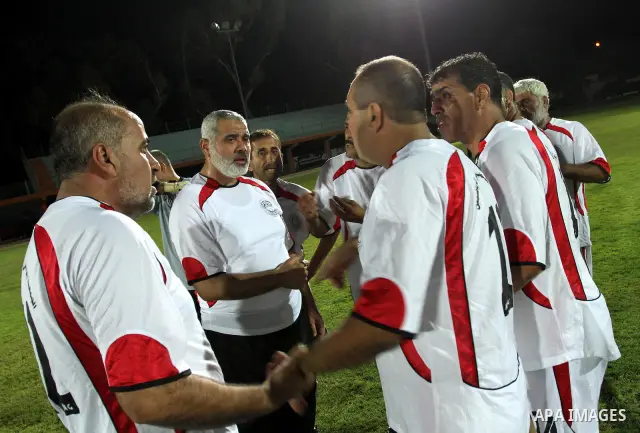 Palestinian prime minister in Gaza Strip, Ismail Haniya participate in football match in solidarity with prisoners jailed in Israel in front of the International Red Cross building in Gaza City, Wednesday, Oct. 12, 2011....