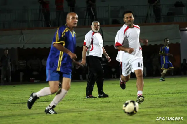 Palestinian prime minister in Gaza Strip, Ismail Haniya participate in football match in solidarity with prisoners jailed in Israel in front of the International Red Cross building in Gaza City, Wednesday, Oct. 12, 2011....