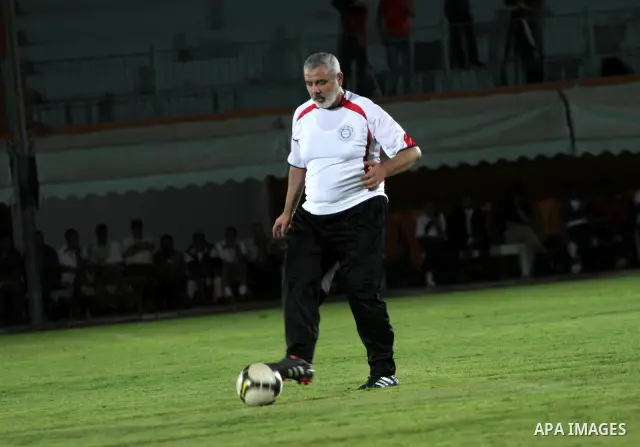 Palestinian prime minister in Gaza Strip, Ismail Haniya participate in football match in solidarity with prisoners jailed in Israel in front of the International Red Cross building in Gaza City, Wednesday, Oct. 12, 2011....