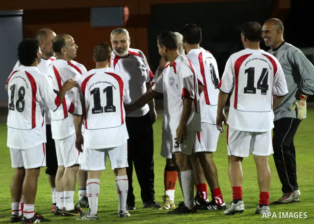 Palestinian prime minister in Gaza Strip, Ismail Haniya participate in football match in solidarity with prisoners jailed in Israel in front of the International Red Cross building in Gaza City, Wednesday, Oct. 12, 2011....