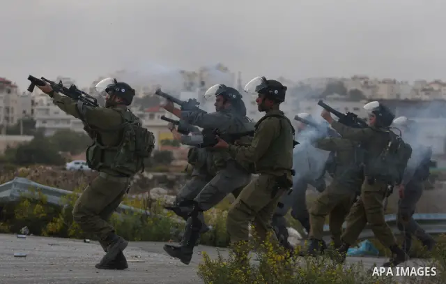Israeli forces clash with Palestinian protestors following a demonstration calling for the release of prisoners held in Israeli jails and in support of inmates in hunger strike, on October 12, 2011 near Israel?s Ofer pri...