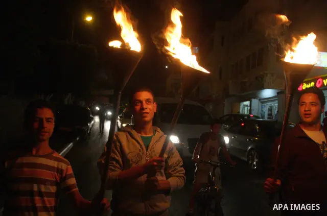 Families of prisoners being held in Israeli jails hold a candlelight vigil at the United Nations and Red Cross headquarters in the West Bank city of Ramallah, on October 12, 2011, to show support for prisoners on their t...