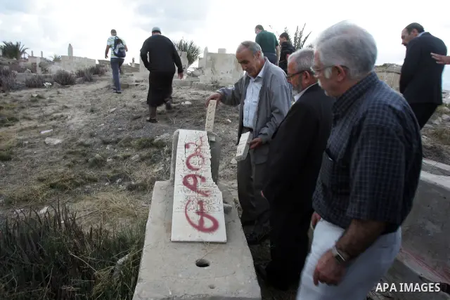 Palestinians inspect the destruction in the graves in the city of Jerusalem on August 6,2010. New plan for the Jerusalem municipality to remove the cemetery of Mamun Allah in West Jerusalem as the graves that marked in r...