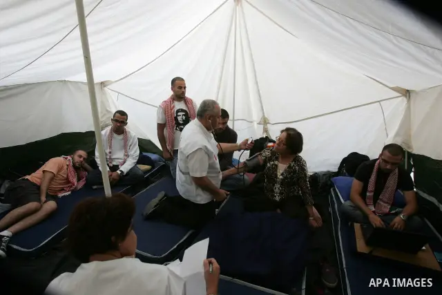 Palestinians take part in a protest in solidarity with their relatives Palestinian prisoners held in Israeli jails in a protest tent in front of the Red Cross' offices in east Jerusalem, on Oct,12, 2011.. Photo by Mahfou...