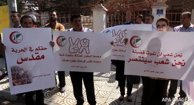 NGOs take part in a rally celebrating a prisoner swap between Hamas and Israel, in Gaza City Oct, 13, 2011. Israelis welcomed on Wednesday a major prisoner swap that will free soldier Gilad Shalit after five years in cap...