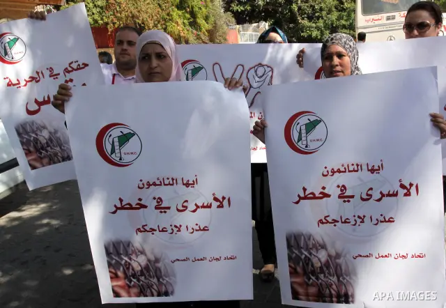 NGOs take part in a rally celebrating a prisoner swap between Hamas and Israel, in Gaza City Oct, 13, 2011. Israelis welcomed on Wednesday a major prisoner swap that will free soldier Gilad Shalit after five years in cap...