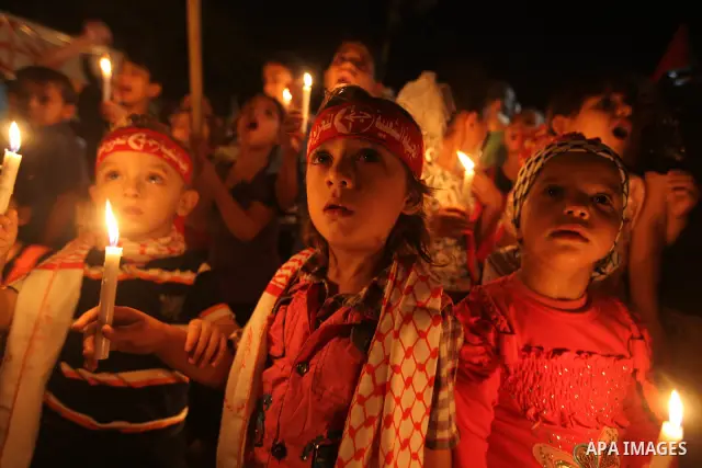 Palestinian children hold candles during a rally in solidarity with Palestinian prisoners held in Israeli jails, in Gaza City October 13, 2011. Israeli soldier Gilad Shalit will be freed from five years of captivity in t...