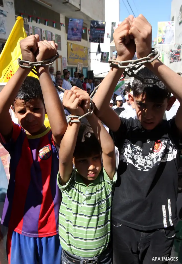 .Palestinians take part in a rally supporting the prisoners in Israeli jails in the Askar refugee camp in the West Bank city of Nablus, Friday Oct. 14, 2011. The case of prisoners in Israeli jails is deeply sensitive for...