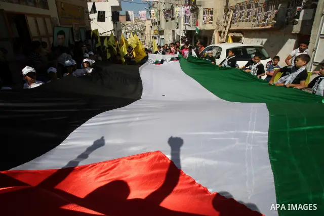 Palestinians take part in a rally supporting the prisoners in Israeli jails in the Askar refugee camp in the West Bank city of Nablus, Friday Oct. 14, 2011. The case of prisoners in Israeli jails is deeply sensitive for...