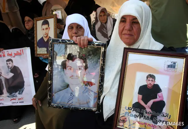 Palestinians take part in a rally supporting the prisoners in Israeli jails in the Askar refugee camp in the West Bank city of Nablus, Friday Oct. 14, 2011. The case of prisoners in Israeli jails is deeply sensitive for...