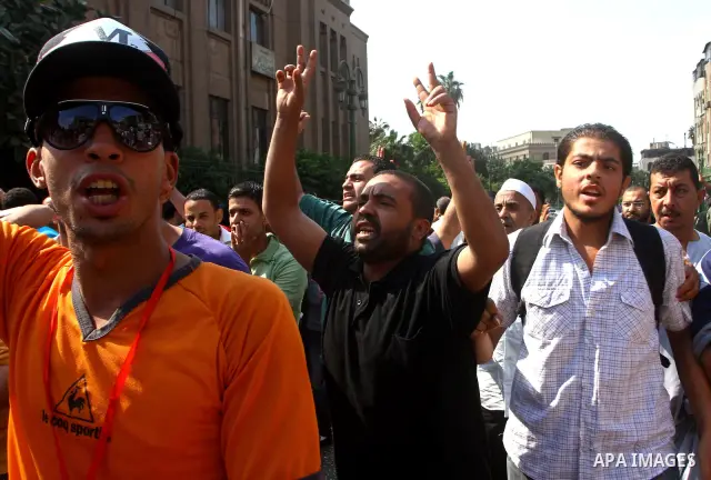 Egyptian protesters shout slogans during a demonstration outside a mosque in Cairo in support of national unity that led to a clash between pro- and anti-military supporters on October 14, 2011. The military has run Egyp...