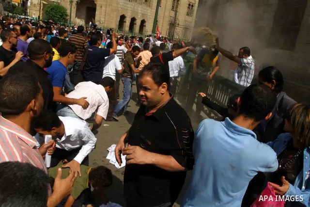 Egyptian pro- and anti-military supporters clash during a demonstration in support of national unity outside a mosque in Cairo on October 14, 2011. The military has run Egypt since president Hosni Mubarak was ousted in F...
