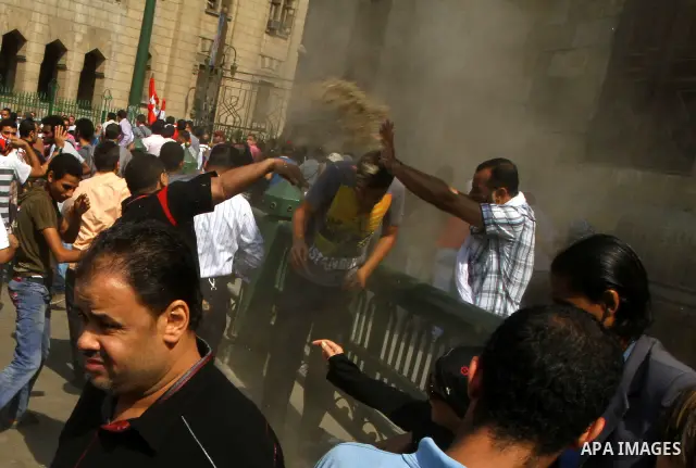 Egyptian pro- and anti-military supporters clash during a demonstration in support of national unity outside a mosque in Cairo on October 14, 2011. The military has run Egypt since president Hosni Mubarak was ousted in F...