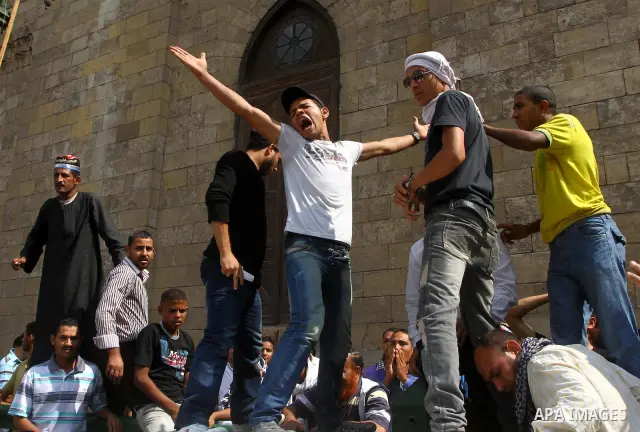 Egyptian protesters shout slogans during a demonstration outside a mosque in Cairo in support of national unity that led to a clash between pro- and anti-military supporters on October 14, 2011. The military has run Egyp...