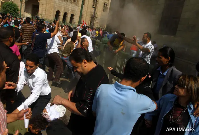 Egyptian pro- and anti-military supporters clash during a demonstration in support of national unity outside a mosque in Cairo on October 14, 2011. The military has run Egypt since president Hosni Mubarak was ousted in F...