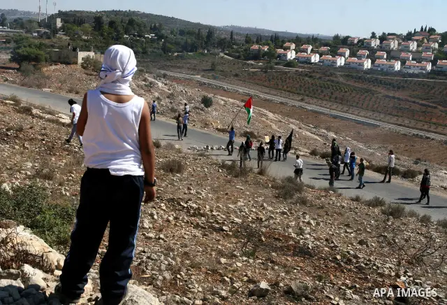 Palestinian protestors take part in a demonstration against the expansion of the nearby Jewish settlement of Halamish in the West Bank village of Nabi Saleh, near Ramallah, Friday, Oct. 14, 2011. Photo by Issam Rimawi