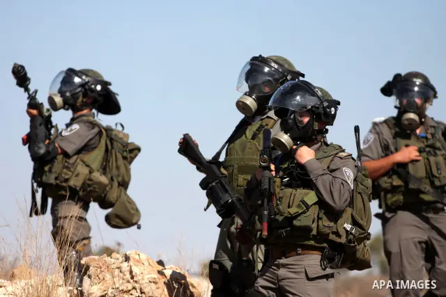 Israeli forces clash with Palestinian stone throwers during a demonstration against the expansion of the nearby Jewish settlement of Halamish in the West Bank village of Nabi Saleh, near Ramallah, Friday, Oct. 14, 2011....