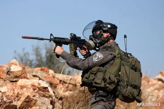 Israeli forces clash with Palestinian stone throwers during a demonstration against the expansion of the nearby Jewish settlement of Halamish in the West Bank village of Nabi Saleh, near Ramallah, Friday, Oct. 14, 2011....
