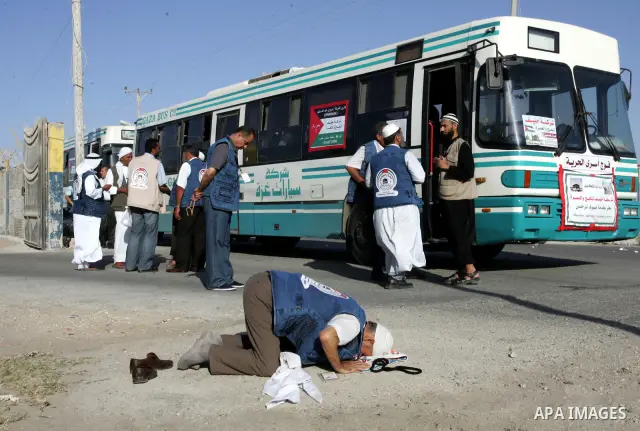 Palestinian pilgrims arrive at the Rafah border crossing between the Gaza Strip and Egypt on their way to the annual hajj or pilgrimage in the Saudi Muslim holy city of Mecca, on October 14, 2011. Photo by Abed Rahim Kha...