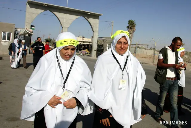 Palestinian pilgrims arrive at the Rafah border crossing between the Gaza Strip and Egypt on their way to the annual hajj or pilgrimage in the Saudi Muslim holy city of Mecca, on October 14, 2011. Photo by Abed Rahim Kha...