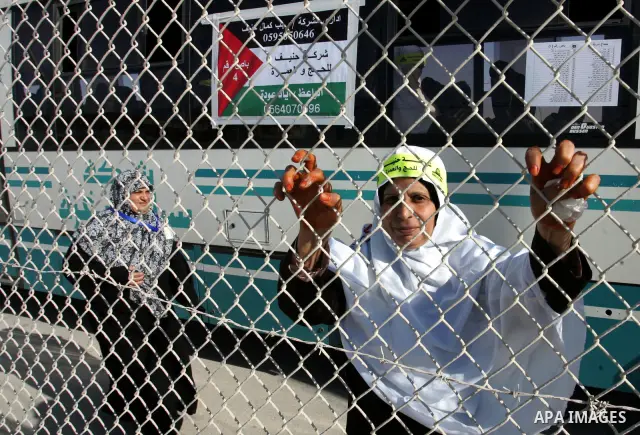 Palestinian pilgrims arrive at the Rafah border crossing between the Gaza Strip and Egypt on their way to the annual hajj or pilgrimage in the Saudi Muslim holy city of Mecca, on October 14, 2011. Photo by Abed Rahim Kha...