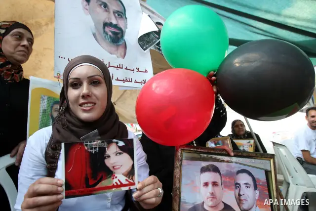 Palestinians celebrate the prisoner exchange deal between Hamas and Israel, in the West Bank city of Nablus Saturday, Oct.15, 2011. It is expected that Hamas will free the captured Israeli soldier Gilad Schalit in exchan...