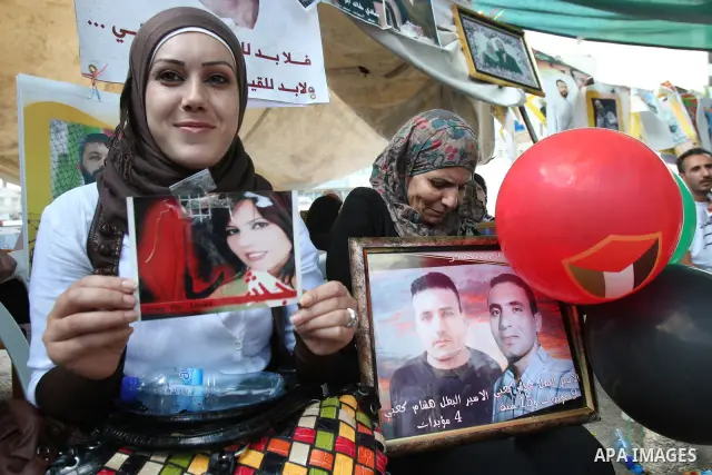 Palestinians celebrate the prisoner exchange deal between Hamas and Israel, in the West Bank city of Nablus Saturday, Oct.15, 2011. It is expected that Hamas will free the captured Israeli soldier Gilad Schalit in exchan...
