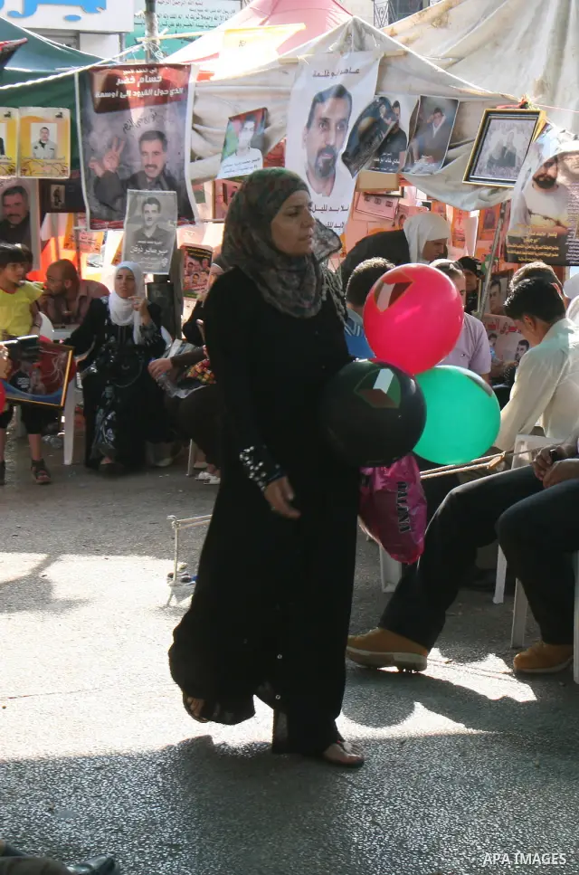 Palestinians celebrate the prisoner exchange deal between Hamas and Israel, in the West Bank city of Nablus Saturday, Oct.15, 2011. It is expected that Hamas will free the captured Israeli soldier Gilad Schalit in exchan...
