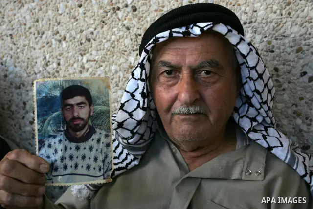 The family of Palestinian prisoner Nasser Nazzal show his picture as they gather at a relative's house in the southern Gaza Strip town of Khan Younis on October 15, 2011 awaiting his release as part of a deal to secure t...
