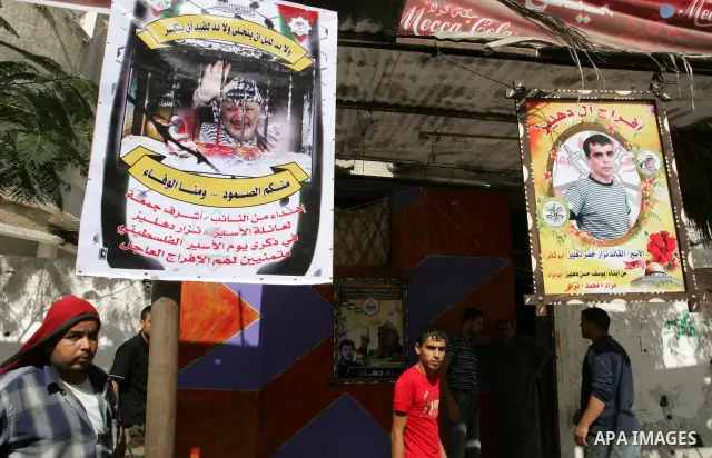 The families of Palestinian prisoners loyal to the leader of the Palestinian Fatah party led by Mahmoud Abbas, Hamas flags decorate their homes in Rafah town in the southern Gaza Strip on October 16, 2011. Israel on Sund...
