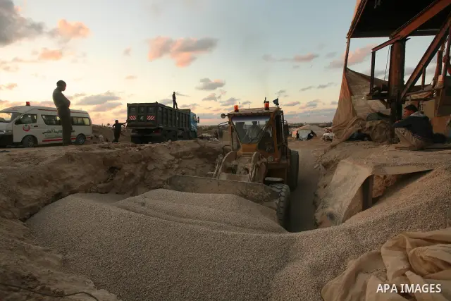 Palestinian men smuggle gravels into the Gaza Strip through a tunnel under the Egypt-Gaza border in Rafah on Oct. 16, 2011. Israel released a list of 477 Palestinian prisoners to be released next week as part of the deal...